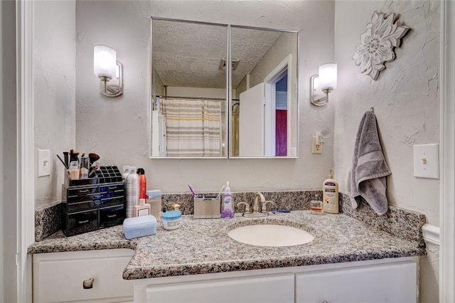 bathroom featuring vanity and a textured ceiling