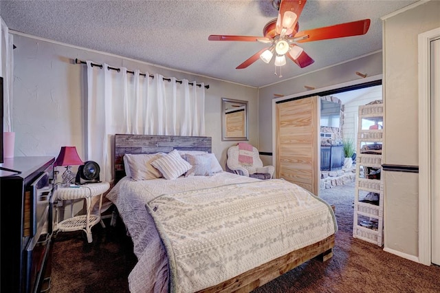 carpeted bedroom with ceiling fan, crown molding, and a textured ceiling