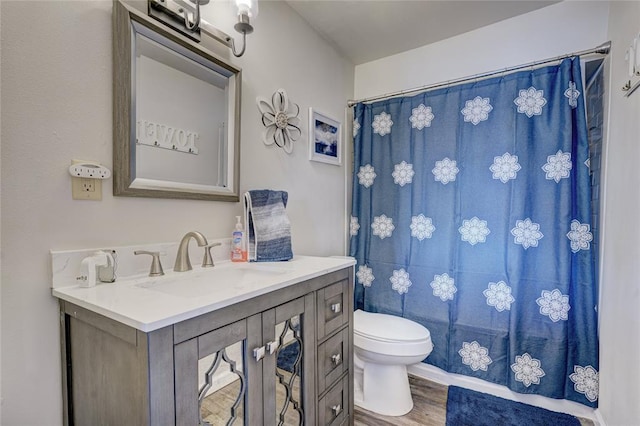 bathroom featuring vanity, curtained shower, toilet, and wood-type flooring