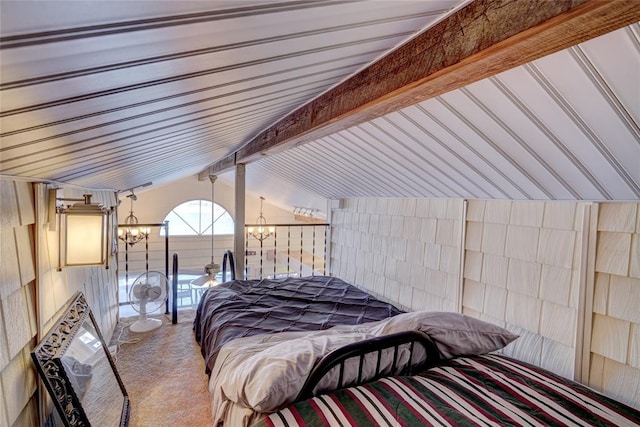 carpeted bedroom with vaulted ceiling with beams and a chandelier