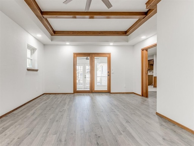 empty room with light hardwood / wood-style flooring, plenty of natural light, and ceiling fan