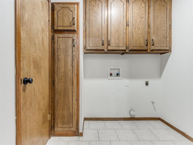 washroom featuring electric dryer hookup, cabinets, gas dryer hookup, hookup for a washing machine, and light tile patterned flooring