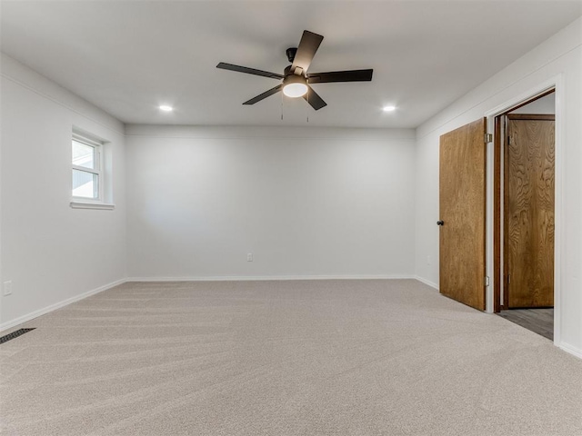 empty room featuring light carpet and ceiling fan