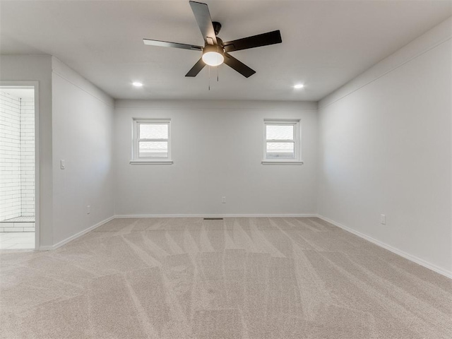 carpeted spare room featuring ceiling fan