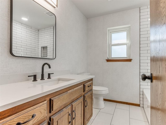 bathroom with tile patterned floors, vanity, and toilet