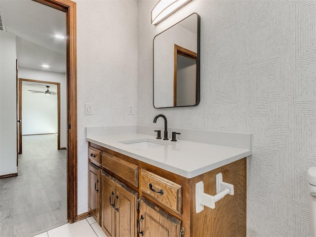 bathroom featuring ceiling fan, vanity, and hardwood / wood-style flooring