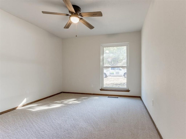 unfurnished room with ceiling fan and light carpet