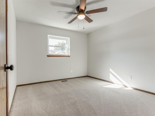 unfurnished room featuring light colored carpet and ceiling fan