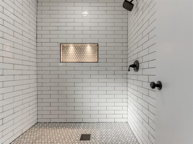 bathroom with a tile shower