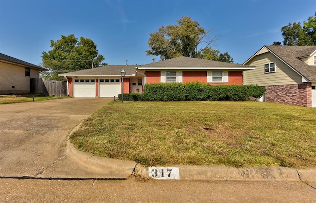 ranch-style home featuring a front lawn and a garage