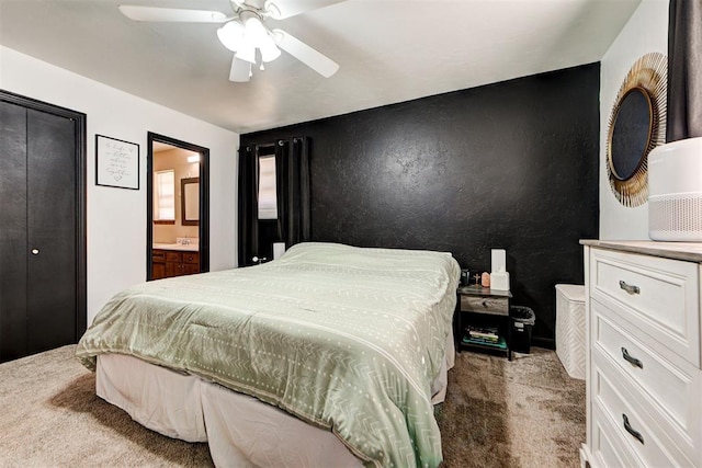 bedroom featuring ceiling fan, light carpet, and connected bathroom