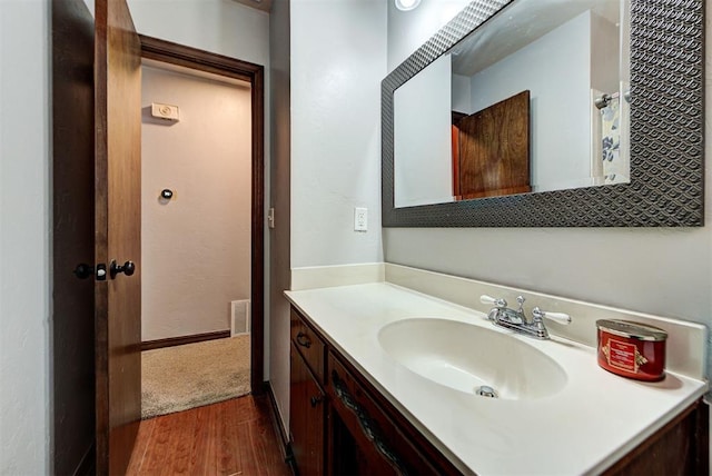 bathroom featuring hardwood / wood-style flooring and vanity