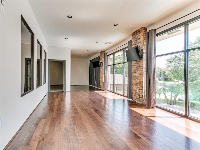 empty room featuring visible vents and wood finished floors