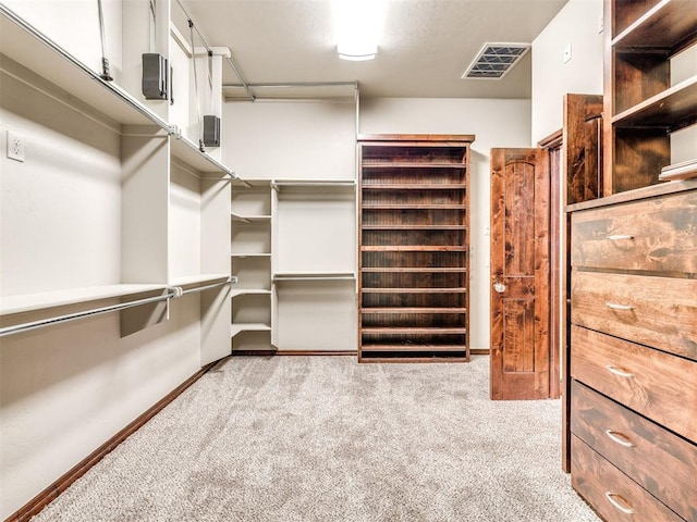 walk in closet with visible vents and carpet flooring