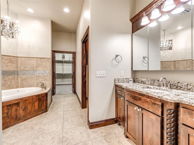 bathroom with visible vents, a garden tub, tile patterned flooring, vanity, and a chandelier