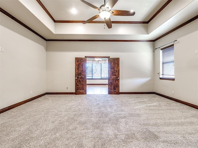 spare room featuring ornamental molding, carpet, plenty of natural light, and baseboards