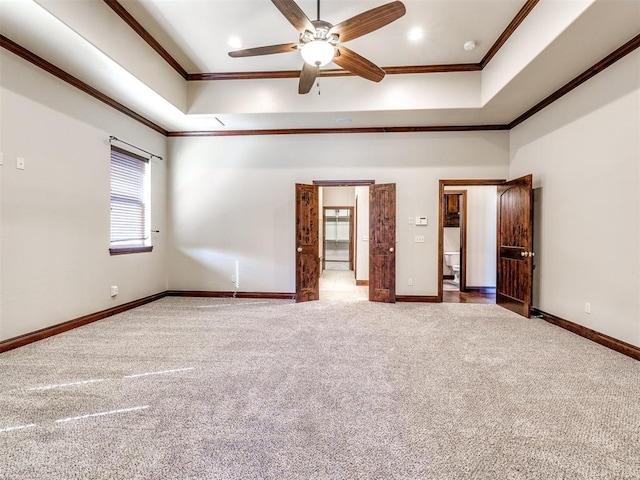 interior space featuring carpet, crown molding, a raised ceiling, a towering ceiling, and baseboards