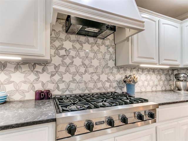 kitchen featuring extractor fan, stainless steel gas cooktop, decorative backsplash, and white cabinets