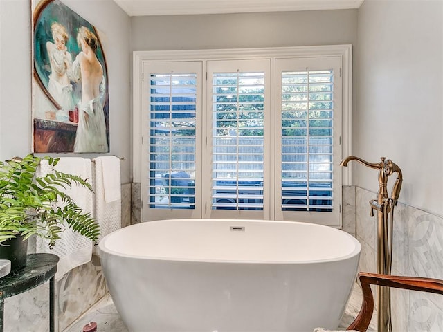 bathroom with tile walls and a tub