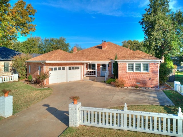 view of front of property with a garage, covered porch, and a front lawn