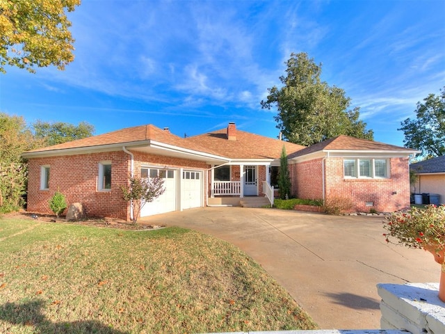 ranch-style home featuring a garage and a front lawn