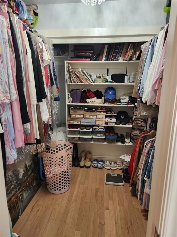 spacious closet featuring hardwood / wood-style floors