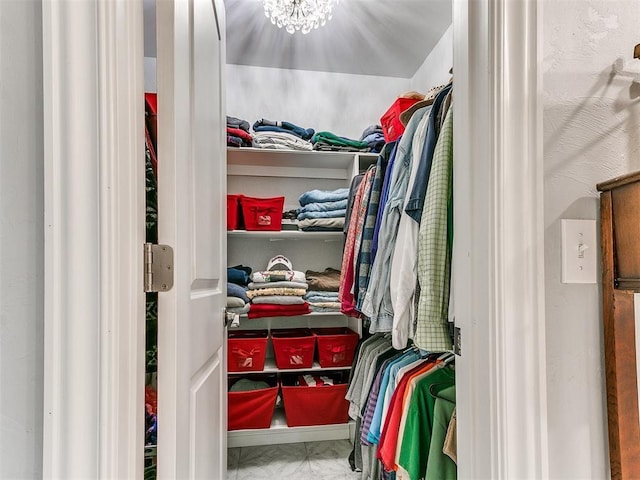 walk in closet with marble finish floor