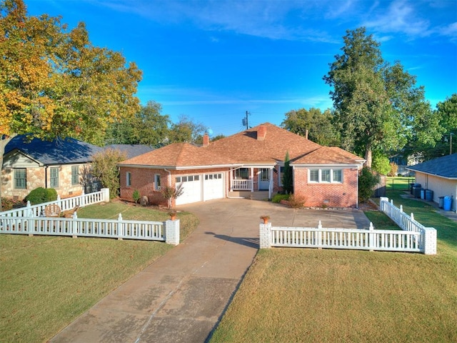 single story home featuring a front lawn, an attached garage, brick siding, and a fenced front yard