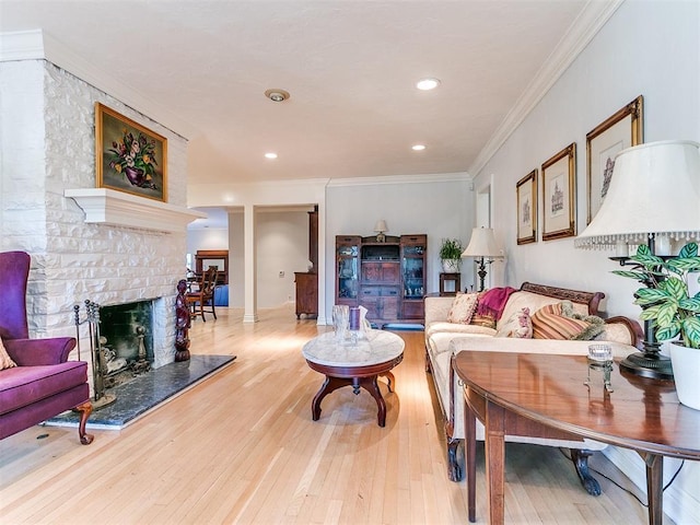 living room featuring recessed lighting, light wood-style floors, a brick fireplace, and crown molding