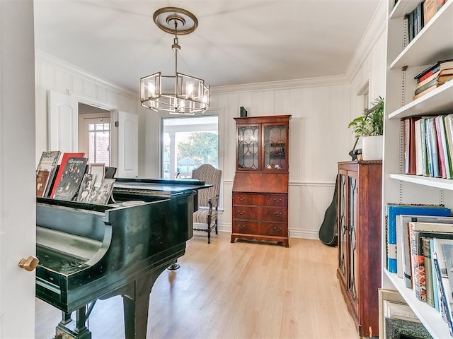 living area with plenty of natural light, crown molding, and light wood-style floors