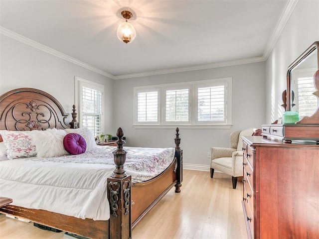 bedroom featuring crown molding, light wood-type flooring, and baseboards