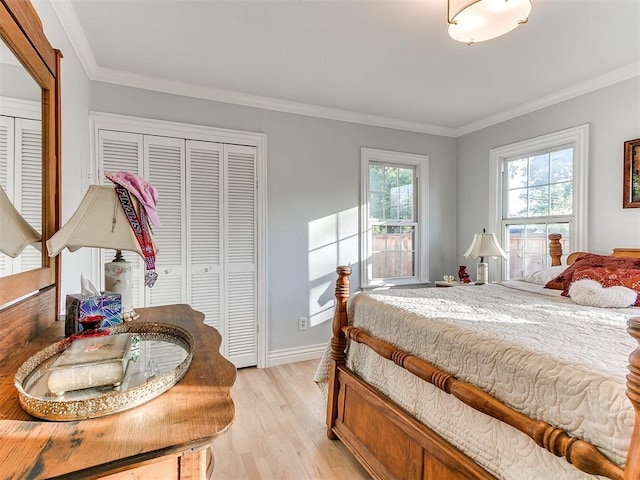 bedroom featuring baseboards, light wood-style floors, and ornamental molding