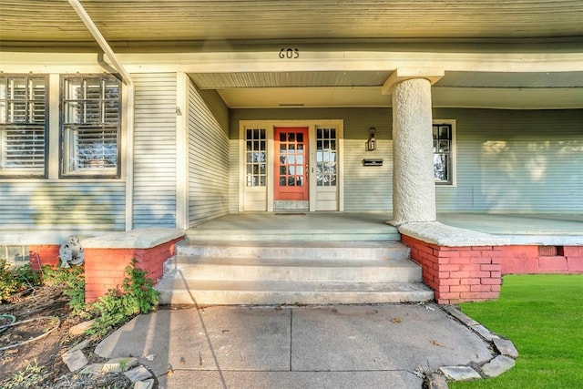 view of exterior entry featuring a porch