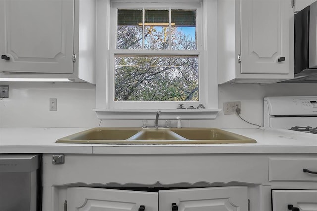 kitchen featuring white cabinets, range, sink, and white dishwasher