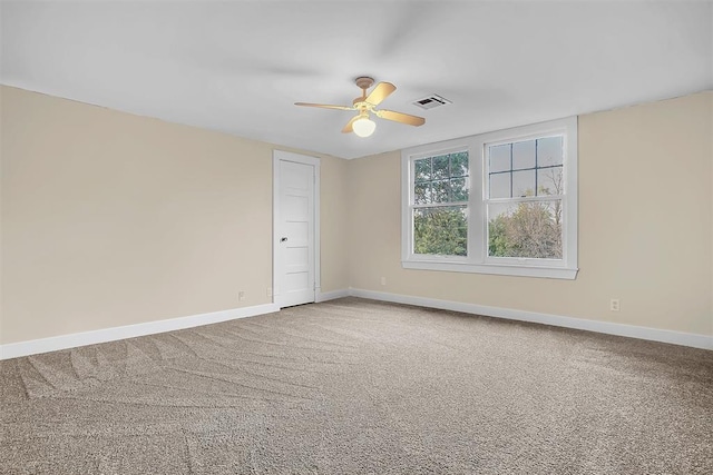 spare room with carpet floors and ceiling fan