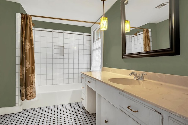 bathroom with tile patterned flooring, shower / bath combination with curtain, and vanity