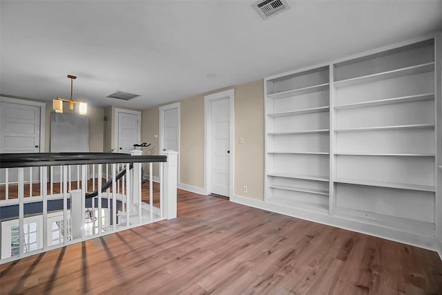 603 N College St, Cordell, OK 73632 - unfurnished room with wood finished floors, built in features, and baseboards