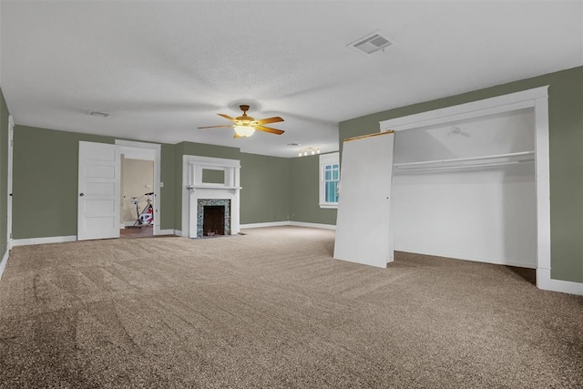 603 N College St, Cordell, OK 73632 - unfurnished living room with a ceiling fan, carpet floors, a fireplace with flush hearth, and baseboards