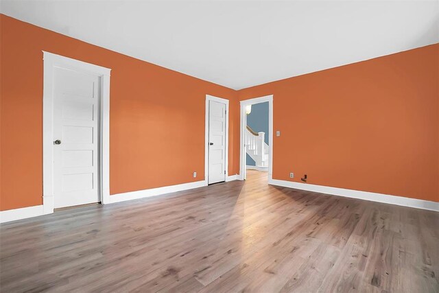 603 N College St, Cordell, OK 73632 - unfurnished room featuring wood finished floors, baseboards, and stairway