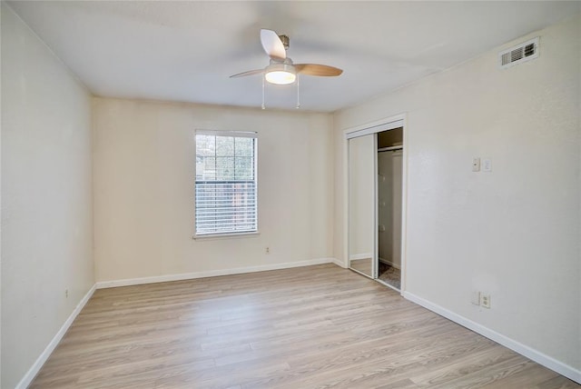 unfurnished bedroom featuring ceiling fan, a closet, and light hardwood / wood-style flooring