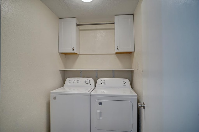 washroom with separate washer and dryer, cabinets, and a textured ceiling