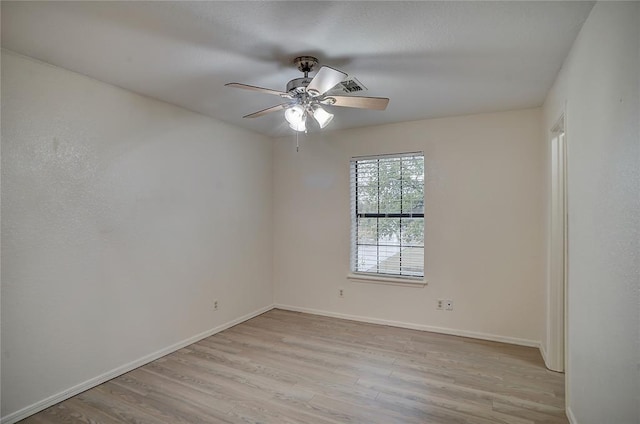 empty room with ceiling fan and light hardwood / wood-style floors