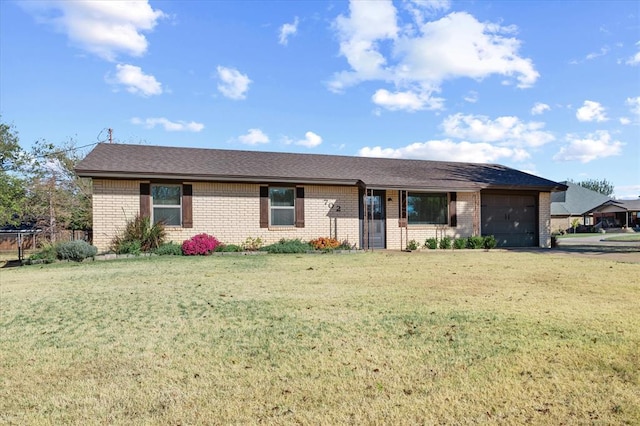 ranch-style home with a garage and a front lawn