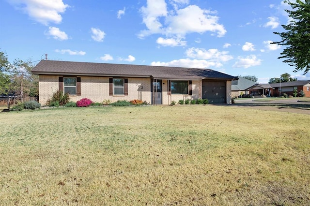 ranch-style house featuring a front yard and a garage