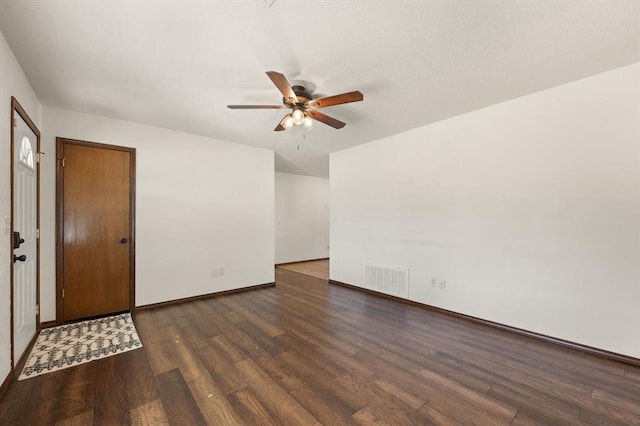 empty room with ceiling fan and dark hardwood / wood-style floors