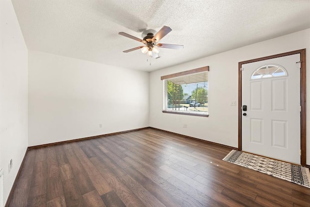 entrance foyer with a textured ceiling, dark hardwood / wood-style flooring, and ceiling fan