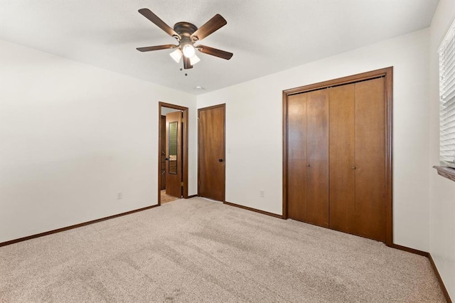 unfurnished bedroom with light carpet, a closet, and ceiling fan