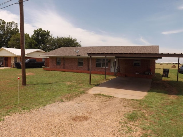 ranch-style home featuring a carport and a front lawn