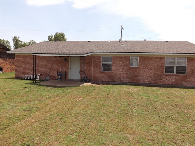 back of property featuring a lawn and a patio area