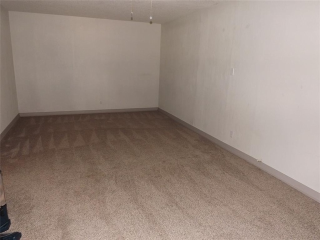 empty room featuring dark colored carpet